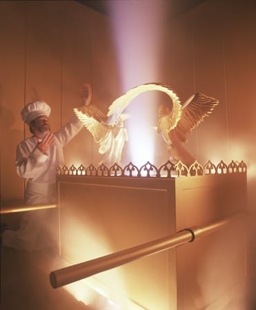 A person praying in a temple Description automatically generated with medium confidence